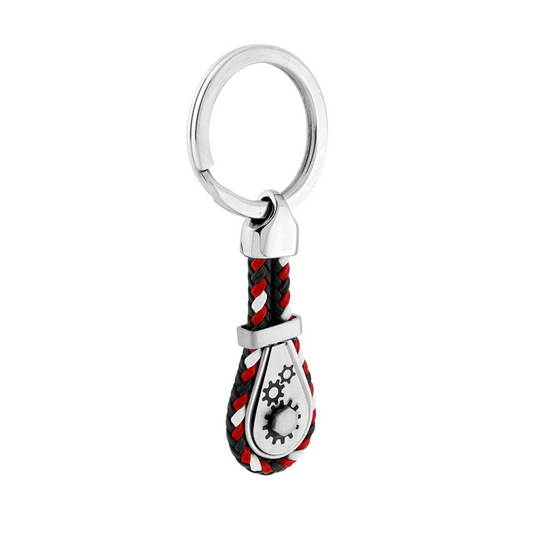 Portachiavi con anello in metallo, cordino intrecciato nero, bianco e rosso, e un ciondolo a forma di ingranaggi.