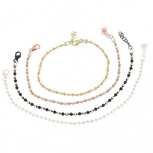 Braccialetti a catena con palline in diversi colori e finiture: argento, oro, oro rosa e argento brunito con palline nere.