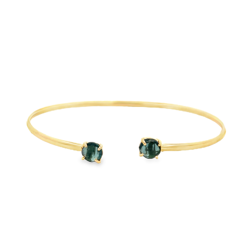 Bracciale a fascia in oro giallo con due pietre preziose blu a taglio cabochon.