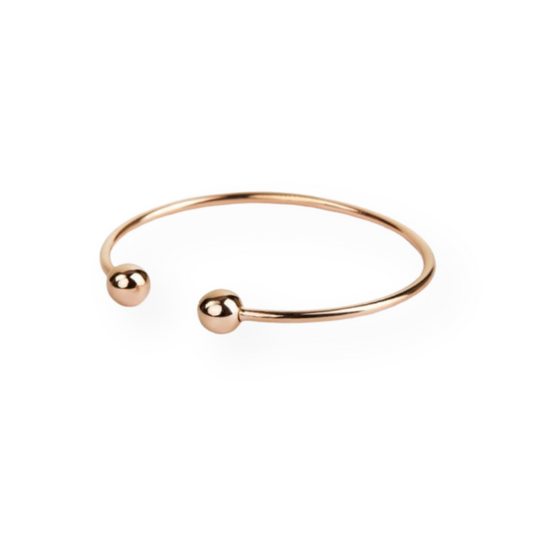 Bracciale rigido a fascia aperta in oro rosa con due palline alle estremità.