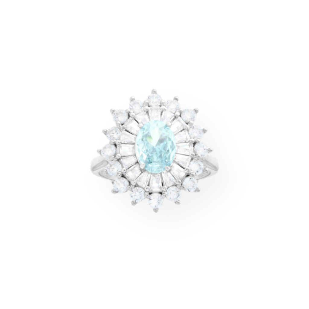 Anello in argento con pietra ovale azzurra centrale circondata da zirconi a forma di baguette e triangolari.