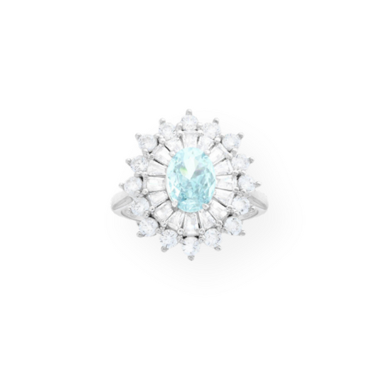 Anello in argento con pietra ovale azzurra centrale circondata da zirconi a forma di baguette e triangolari.