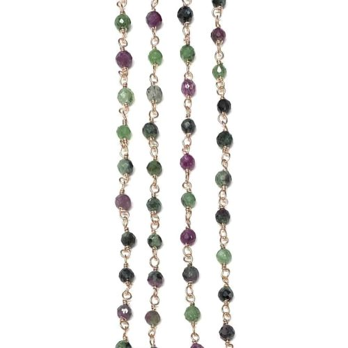 Perle sfaccettate in tonalità di verde e bordeaux, infilate su catenine d'oro.